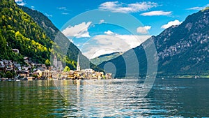 Famous Hallstatt city panorama with typical church near the Hallstatter see. Dramatic clouds on the sky. Famous tourist