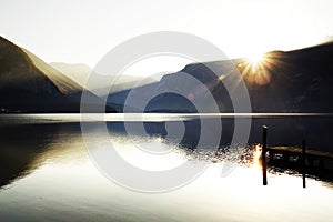 The famous Hallstatt lake - the moment of sunrise in a autumn foggy morning