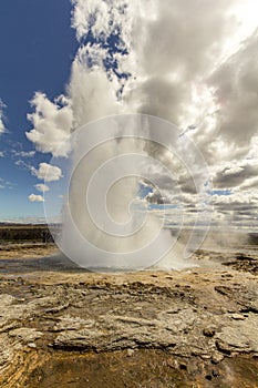 Famous Haukadalur geyser erupting on a sunny day