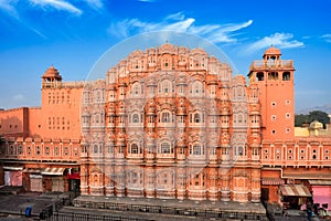 Famous historical landmak pink Hawa Mahal Palace of Winds with people and transport. Jaipur, Rajasthan, India