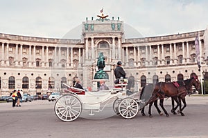 Hofburg Palace and Heldenplatz with a passing carriage with a pair of horses, Vienna, Austria