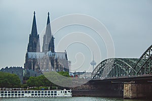 The famous Hohenzollern Bridge with the Cologne Cathedral on a cloudy day in Cologne, Germany