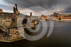 Famous iconic image of Charles bridge at sunset in spring, Prague, Czech Republic. Concept of world travel, sightseeing and