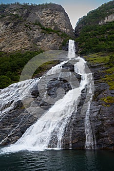 The famous and impressive waterfall The Suitor Friaren dropping down the rocks into the Geiranger Fjord