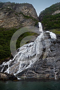 The famous and impressive waterfall The Suitor Friaren dropping down the rocks into the Geiranger Fjord