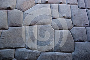 Famous Inca angled stone in Hatun Rumiyoc wall, an archeological artefact in Cuzco, Peru.