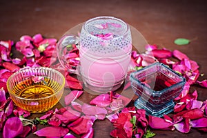 Famous Indian & Asian Summer and Ramadan drink i.e. Gulab shake or Rose falooda in a glass on wooden surface.