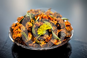 Famous Indian & Gujarati snack dish in a glass plate on wooden surface i.e. Patra or paatra consisting of mainly Colocasia