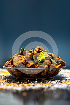 Famous Indian & Gujarati snack dish in a glass plate on wooden surface i.e. Patra or paatra consisting of mainly Colocasia