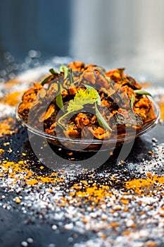 Famous Indian & Gujarati snack dish in a glass plate on wooden surface i.e. Patra or paatra consisting of mainly Colocasia