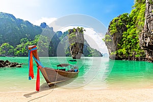 Travel photo of James Bond island with thai traditional wooden longtail boat and beautiful sand beach in Phang Nga bay, Thailand photo