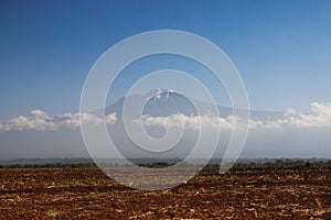 The famous Kilimanjaro volcano in the clouds. The highest point in Africa is located on the border of Kenya and Tanzania.