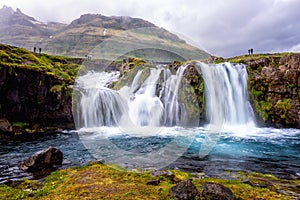 Famous Kirkjufellsfoss waterfall, favorite tourist destination in Iceland. Amazing dramatic landscape