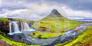 Famous Kirkjufellsfoss waterfall with Kirkjufell church mountain on the background, beautiful landscape, Iceland