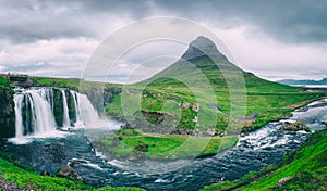 Famous Kirkjufellsfoss waterfall with Kirkjufell mountain, panoramic landscape, Snaefellsnes peninsula, Iceland