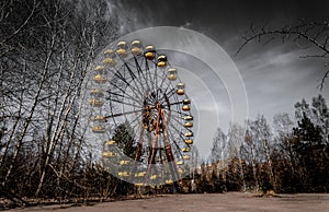Old ferris wheel in the ghost town of Pripyat. Consequences of the accident at the Chernobil nuclear power plant photo