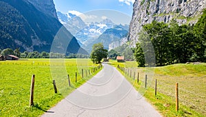 Famous Lauterbrunnen valley with gorgeous waterfall and Swiss Alps