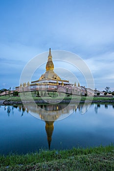 Famous Maha Mongkol Bua Pagoda in Roi-ed Thailand at sunset.