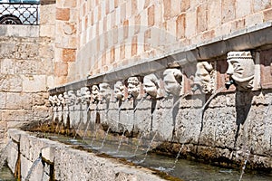 Famous mediaeval Fountain of 99 Spouts in ithe old town of L\'Aquila, Italy