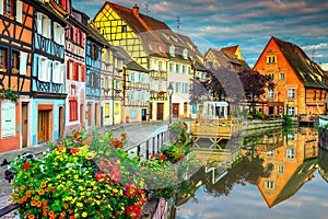 Famous medieval half-timbered facades reflecting in water, Colmar, France