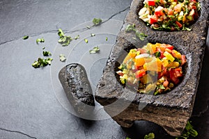 Famous mexican sauces salsas - pico de gallo, salsa bandera mexicana in stone mortars on gray slate background photo