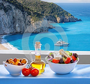 Milos beach with greek salad on Lefkas island in Greece photo