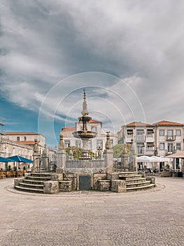 Famous monument of Chafariz do Terreiro in the center of the village of Caminha surrounded by terraces with tourists photo