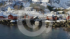 Famous multicolored wooden fishing houses rorbu on a sea shore