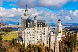 Famous Neuschwanstein Castle in the background Alps mountains and trees. Fussen, Bavaria, Germany