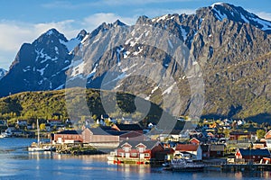 Famous Norwegian Reine The Fishing village  , Lofoten Islands,  Norway. Mountains With Snow In Background,