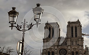 Famous Notre Dame cathedral with Parisian streetlamps in the foreground