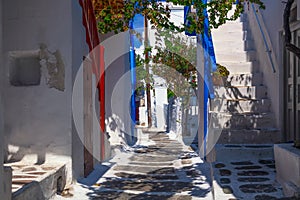 Famous old town narrow street with white houses. Mykonos island, Greece