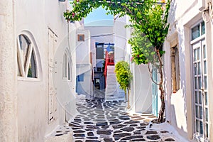 Famous old town narrow street with white houses. Mykonos island, Greece