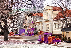 Famous old town of Warsaw with church, christmas tree, toy train and gifts. Poland.
