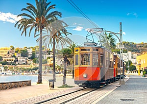 The famous orange tram runs from Soller to Port de Soller, Mallorca, Spain photo