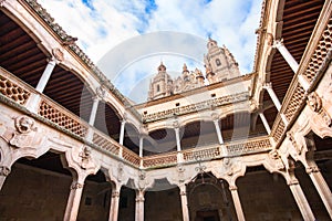 Famous Patio de la Casa de las Conchas with La Clerecia Church in Salamanca, Castilla y Leon, Spain photo