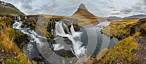 Famous picturesque Kirkjufell mountain and Kirkjufellsfoss waterfall next to GrundarfjÃ¶rÃ°ur at West Iceland autumn view