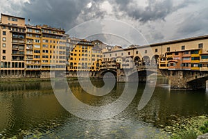 Famous Ponte Vecchio bridge and cityscape view of old town Florence by Arno river in Florence, Italy