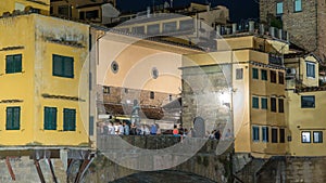 Famous Ponte Vecchio bridge timelapse over the Arno river in Florence, Italy, lit up at night