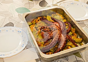 Famous portuguese dish `Polvo a lagareiro`. Homemade roasted octopus with potatoes ready to eat. photo