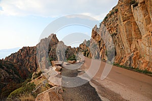 Famous red badlands  called Calanques de Piana of western Corsica and the road called D81