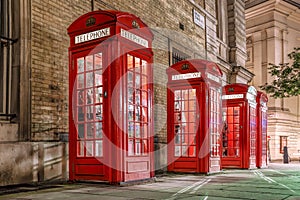 Famous red telephone booths in the evening, Covent Garden street, London, England photo