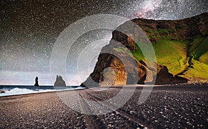 Famous Reynisdrangar rock formations at black Reynisfjara Beach. Coast of the Atlantic ocean near Vik, southern Iceland