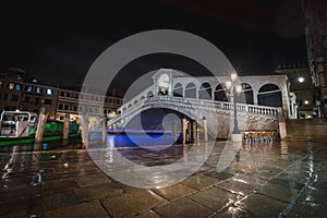 Famous rialto bridge in Venice during a rainy night and very few tourists due to corona virus crisis. Major tourist attractions