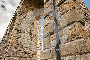 Famous Ribble Valley viaduct railway crossing showing detail of the stonework under-structure and guttering.