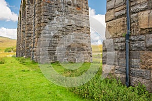 Famous Ribble Valley viaduct railway crossing showing detail of the stonework under-structure and guttering.