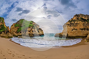 Famous rock formation in a bay on the beach of Tres Irmaos in Alvor, PortimÃ£o, Algarve, Portugal, Europe. Praia dos Tres Irmaos.