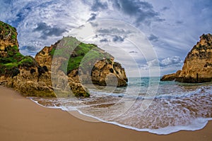 Famous rock formation in a bay on the beach of Tres Irmaos in Alvor, PortimÃ£o, Algarve, Portugal, Europe. Praia dos Tres Irmaos.