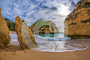 Famous rock formation in a bay on the beach of Tres Irmaos in Alvor, PortimÃ£o, Algarve, Portugal, Europe. Praia dos Tres Irmaos.