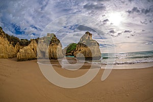 Famous rock formation with the cave on the beach of Tres Irmaos in Alvor, PortimÃ£o, Algarve, Portugal, Europe.